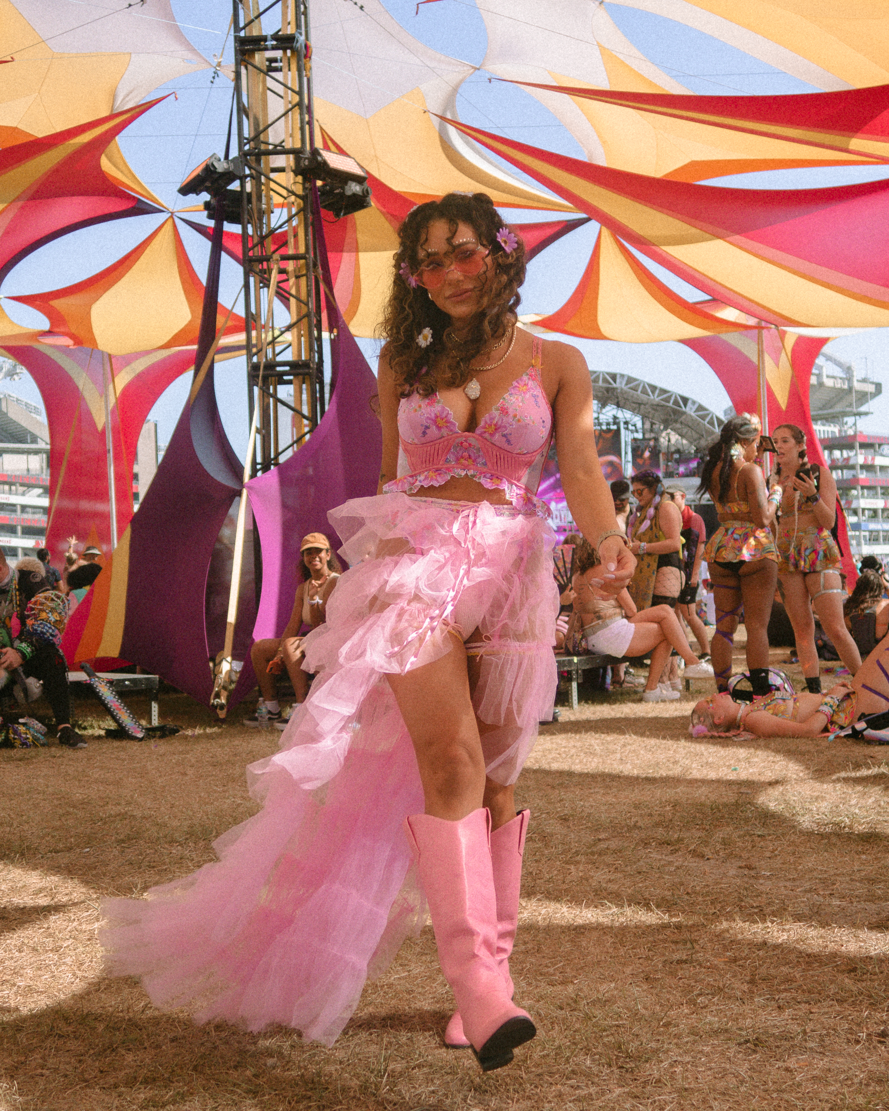 pink tulle skirt floral flower cowboy cowgirl boots curly hair outfit rave raver girl chain belt grunge fashion sunset music festival 2022 outfit ideas boho western music festival brown burning man etc orlando idclv rave outfit inspo inspiration ideas 